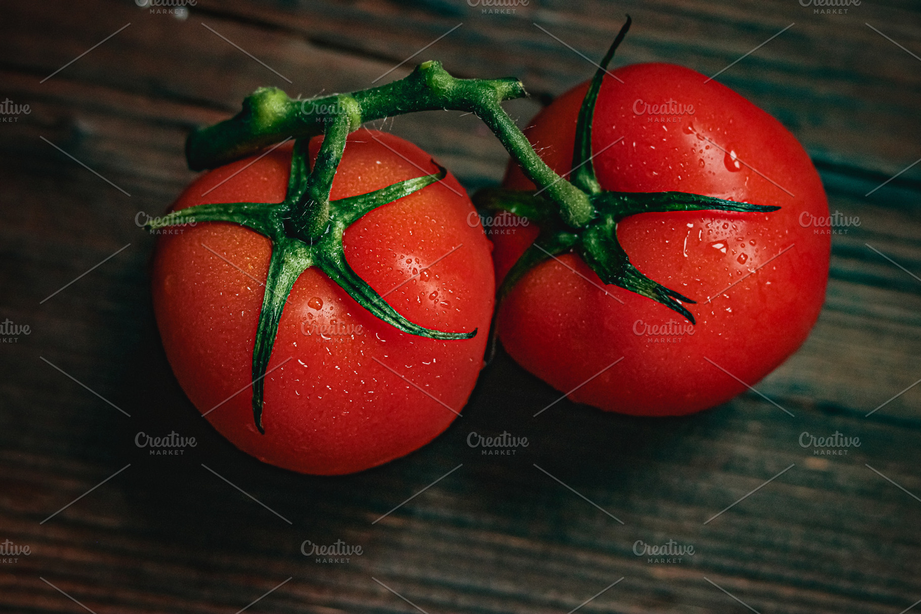 Fresh vine ripened tomatoes on rustic wooden surface with water drops represent, a Photo by Studio ANNA