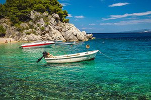 Amazing beach with motor boats, a Transportation Photo by Alpine Dreams