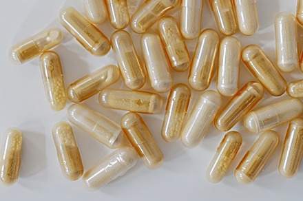 Colorful medicine capsules on white background, a Health & Medical Photo by AlyaAnd