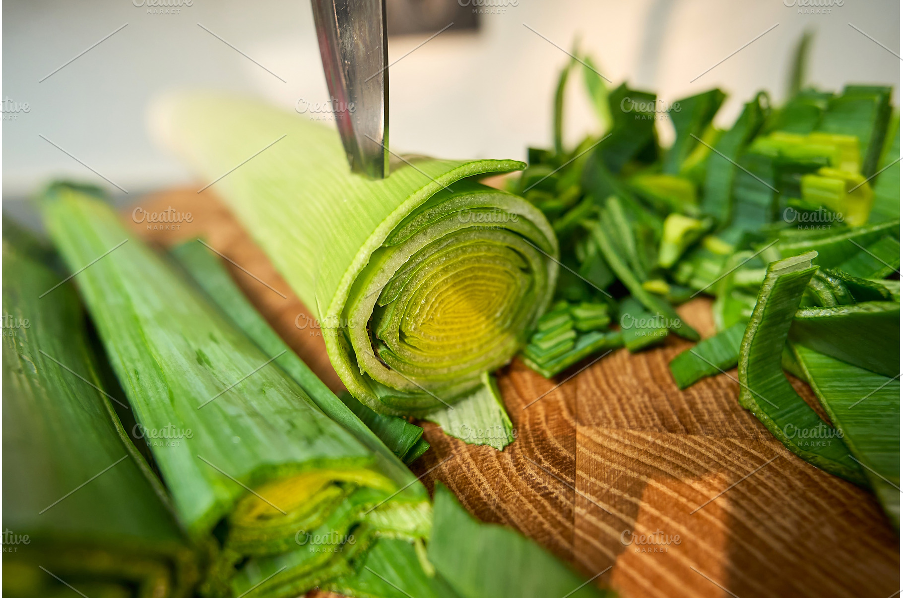 A person is cutting leeks on a, a Food & Drink Photo by darksoul72