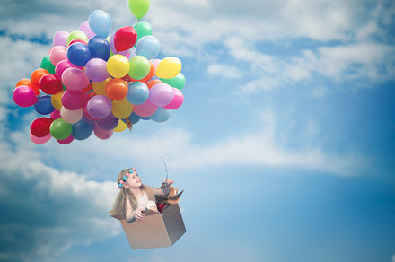 Happy girl flying in a cardboard box on the balloons, a Nature Photo by Kozorog