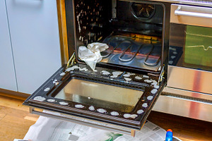 Cleaning the oven, a Photo by Patricia Hofmeester