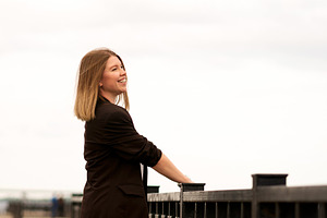 Young woman in black jacket smiling, a Person Photo by Elena Vagengeim