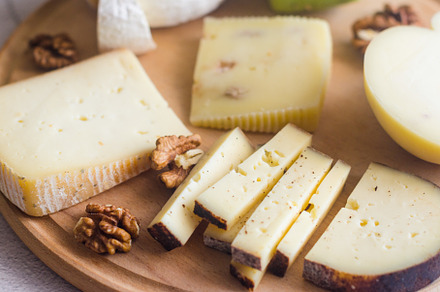 Delicious cheese mix with grapes, jam, snacks, crackers, walnuts, a Food & Drink Photo by vimart