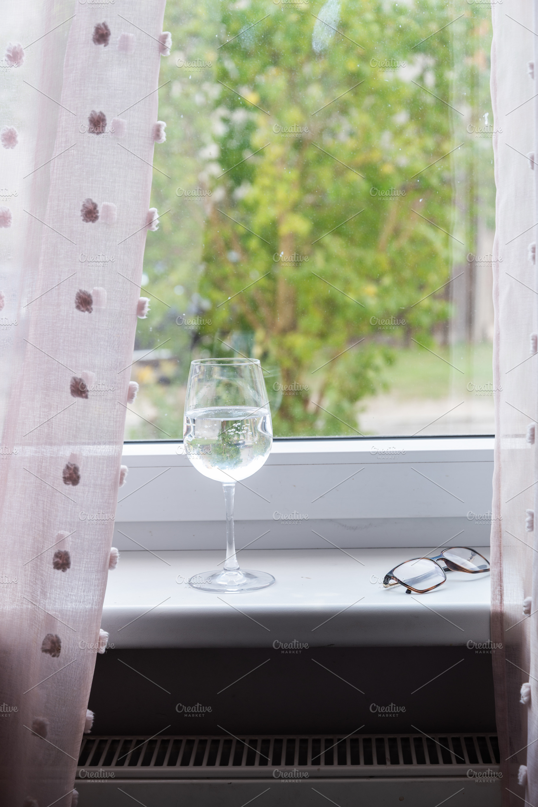 Empty wine glass on windowsill with soft daylight, an Industrial Photo by MDBildes