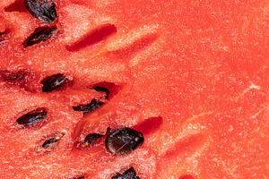 part of a sliced juicy watermelon with black seeds, a Photo by rsoollAI