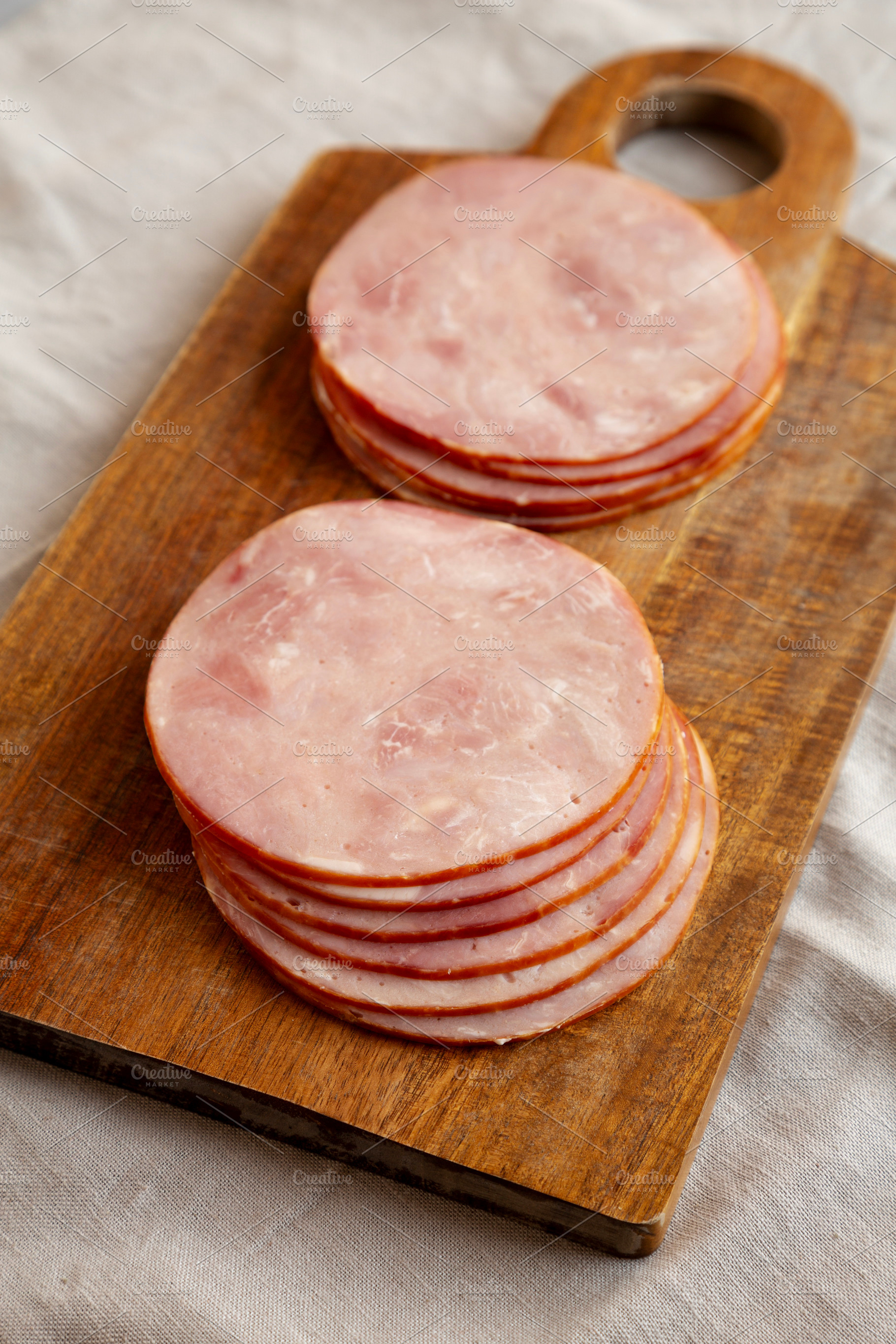 Organic Smoked Cold Cuts Deli Meat Ham on a wooden board, side v, a Food & Drink Photo by LiudmylaChuhunova