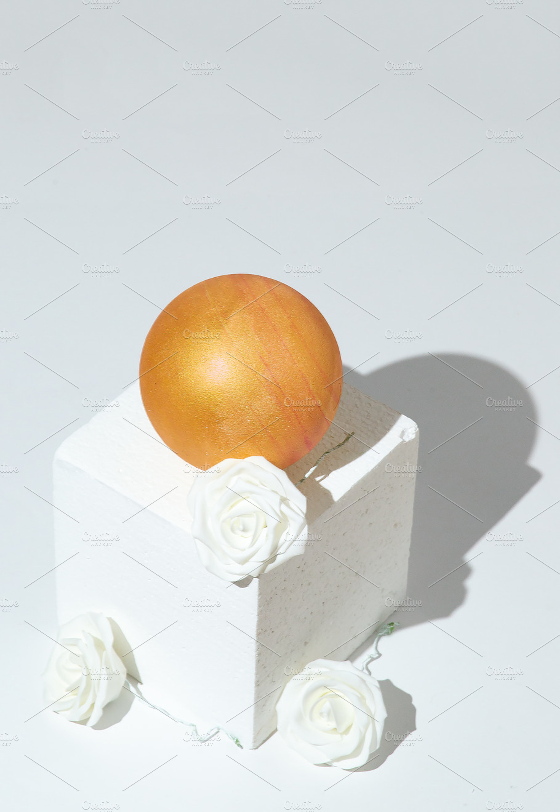 Stylish winter geometric scene white cube, gold ball and roses d, a Holiday Photo by Jenya Porechenskaya