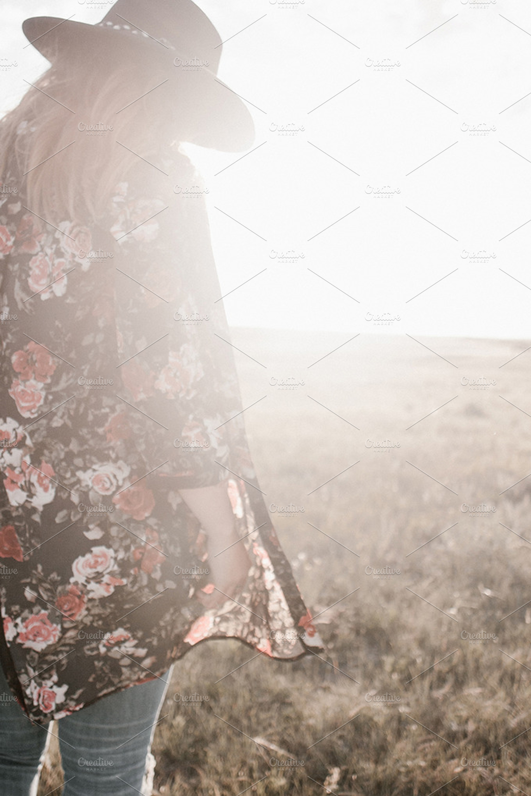Woman walking in a field at sunset, a Person Photo by Wild Wander Collective