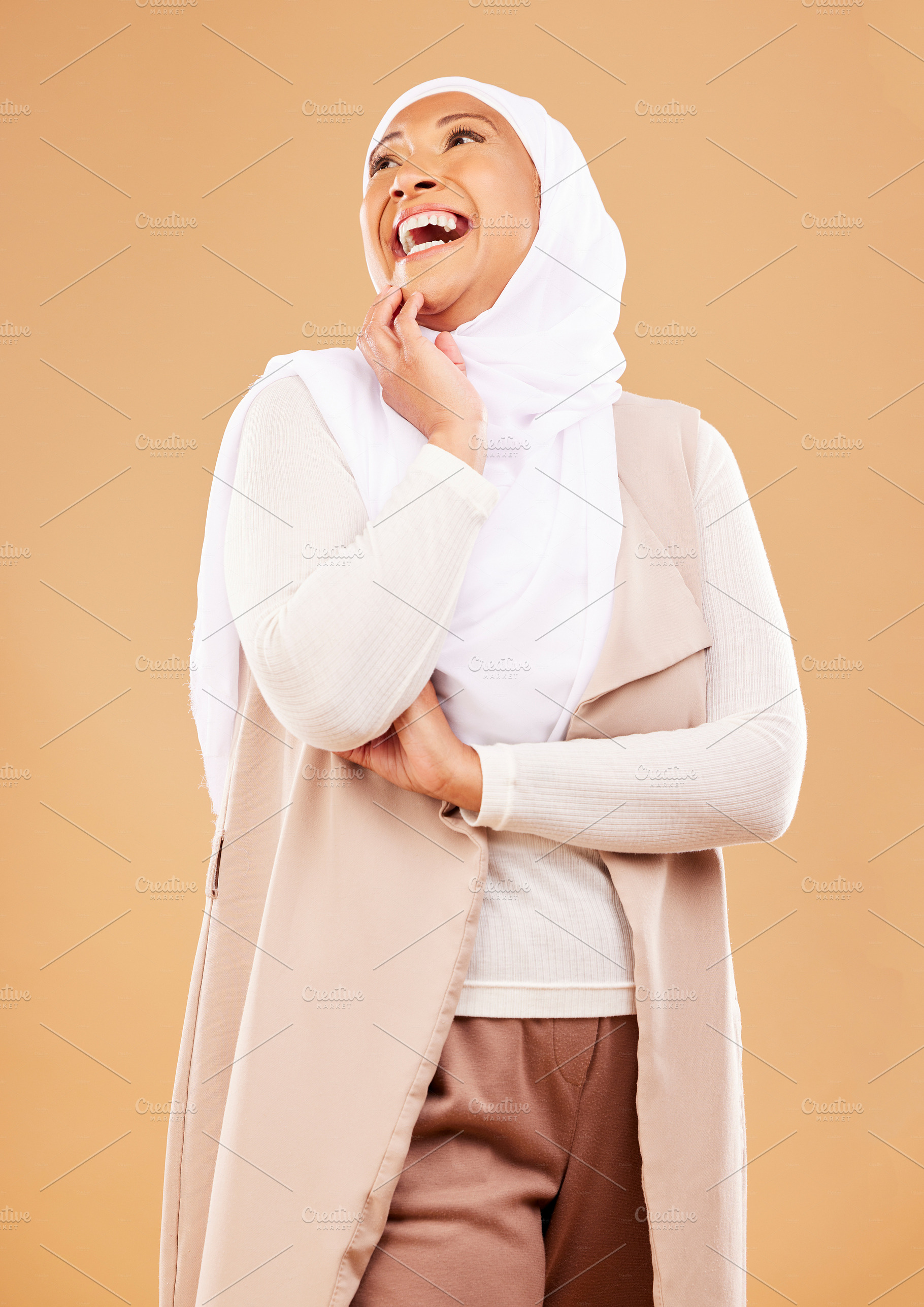 Fashion, beauty and Islamic woman with business clothes, wellness and thinking on brown studio background. Muslim female, Arabic lady and stylish hijab with smile, mockup or creative career with idea, a Photo by Peopleimages.com