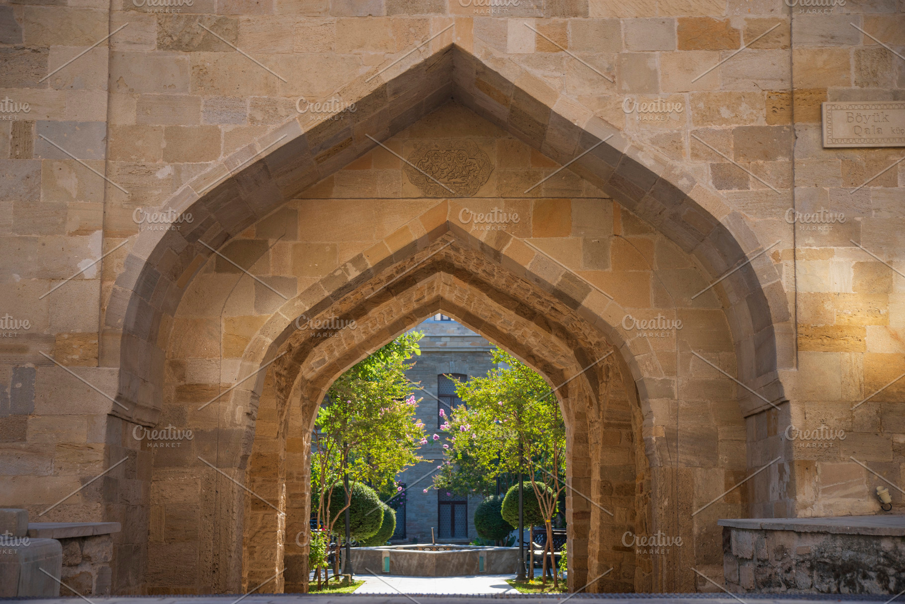 Stone arch in Baku old town with a view of green garden with cop, a Photo by Pictures for you!!!!!!!!!