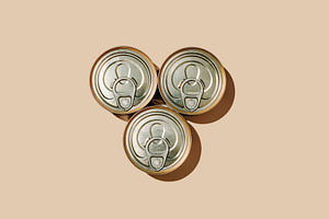 three unopened food cans arranged in a triangle, a Photo by Nito
