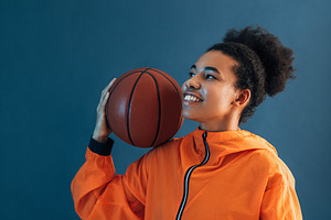 Smiling woman in orange clothes, a Sports & Recreation Photo by Artem Varnitsin