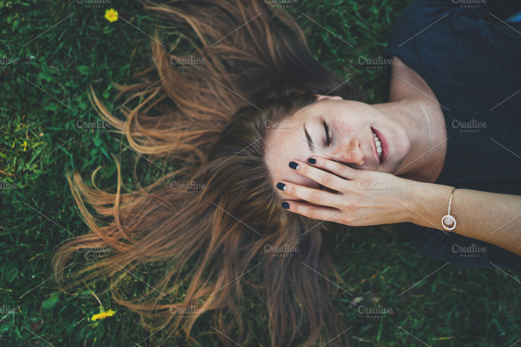 Happy smiling girl featuring lying, woman, and grass, a Holiday Photo by ImYanis
