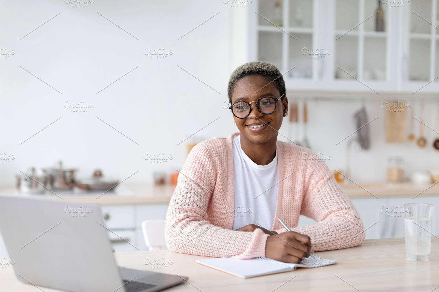 Glad millennial african american female in glasses work or study at laptop at w, a Person Photo by Prostock-Studio