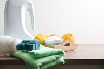 House cleaning supplies on wooden table with white isolated back, a Health & Medical Photo by Davizro's Market
