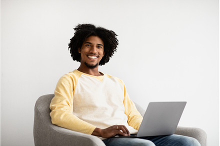 Remote Career. Smiling Black Guy, a Technology Photo by Prostock-Studio