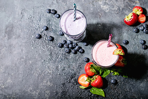 Fresh strawberry and blueberry milks featuring strawberry, milk, and juice