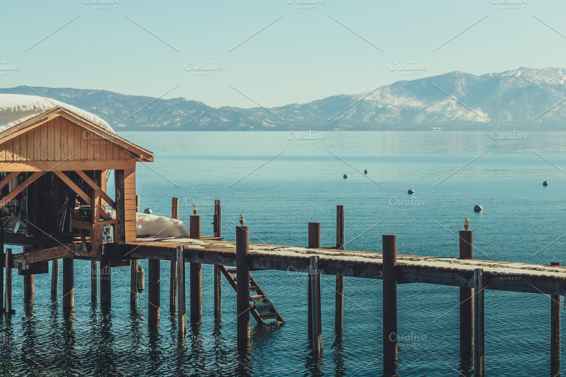Pier On Tahoe Lake Featuring Winter Snow And Mountains