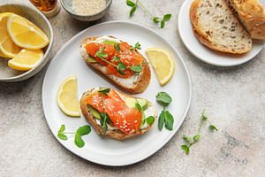 Salmon bruschetta with cream cheese and avocado slices, a Food & Drink Photo by Olena Rudo