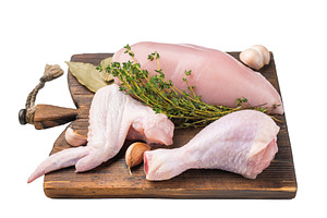 Raw chicken cuts: boneless breast, wing, and drumstick on a rust, a Photo by composter-box@mail.ru