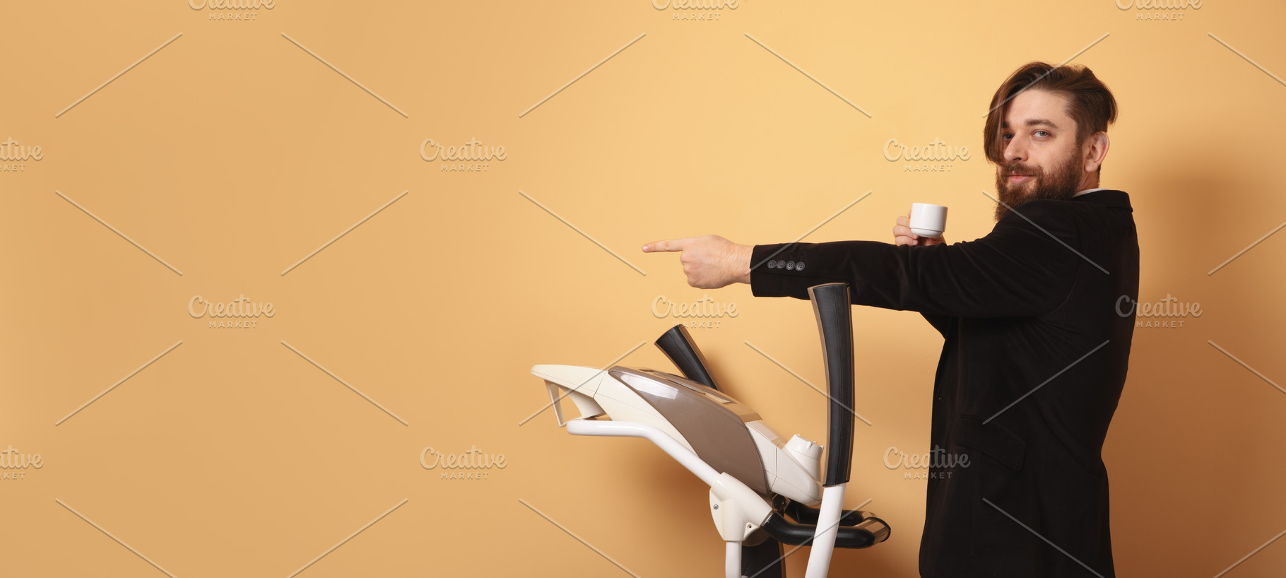 Confident young businessman holding coffee and pointing while st, a Person Photo by Ales Munt