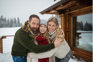 Family standing on the snowy cabin, a Person Photo by HalfPoint