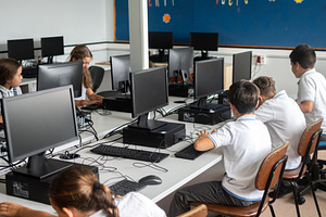 Elementary school students using desktop computers in computer lab, a School & Education Photo by etorres69