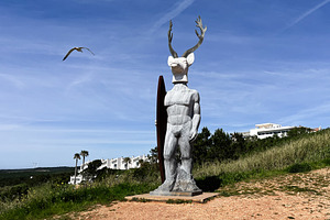 Intriguing statue in Nazare Portugal with blue sky and open landscape, a Photo by AS photostudio