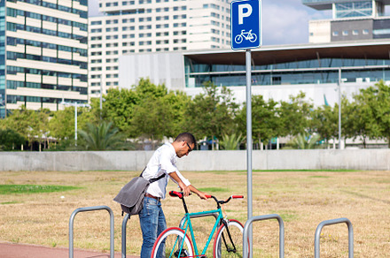 hipster man parking fixed gear bike on city street, a Person Photo by RF Images