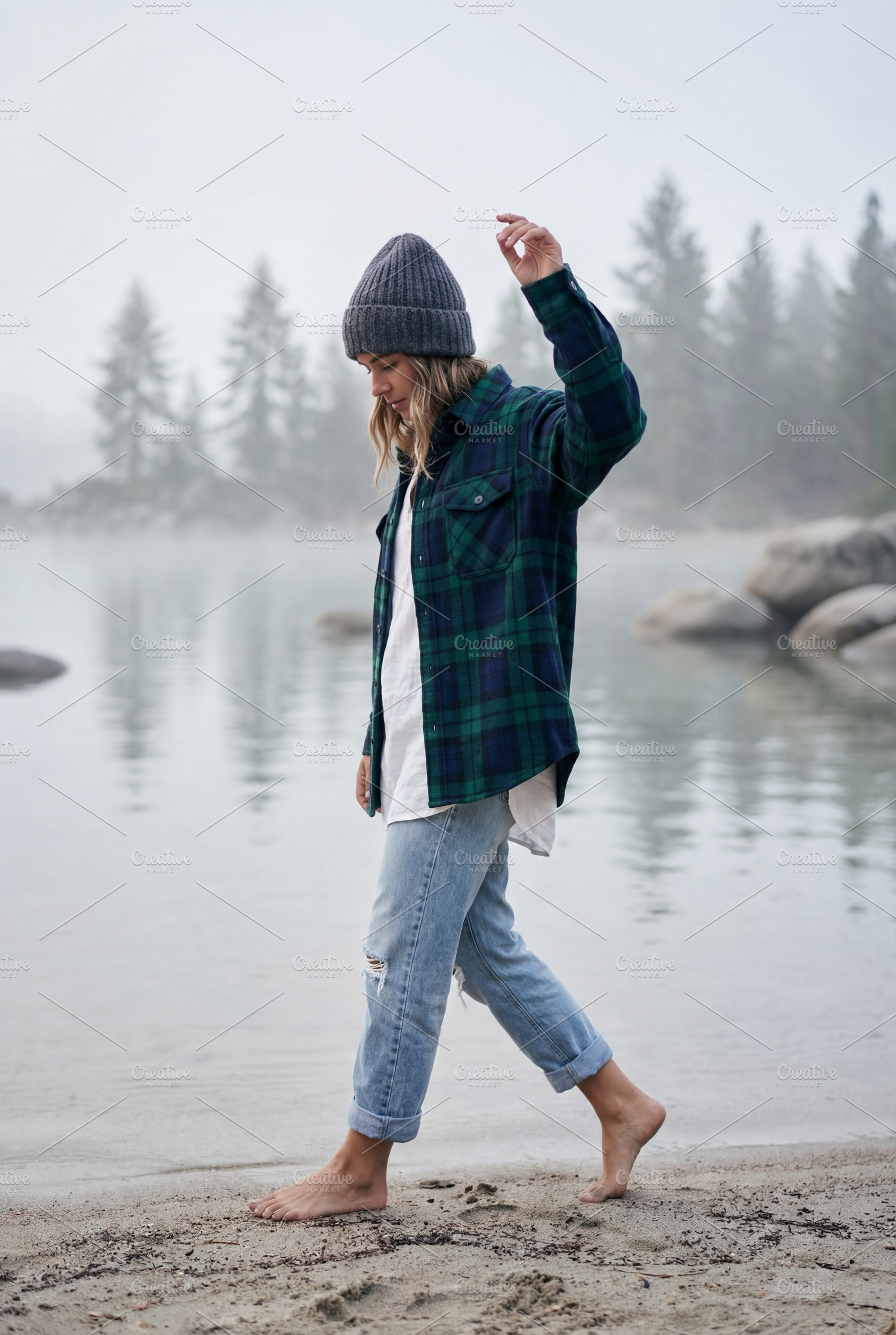Woman walking barefoot on lakeshore, a Photo by Virgo Studio