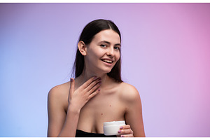 Woman applying moisturizing cream to, a Health & Medical Photo by volodymyrshtun13795