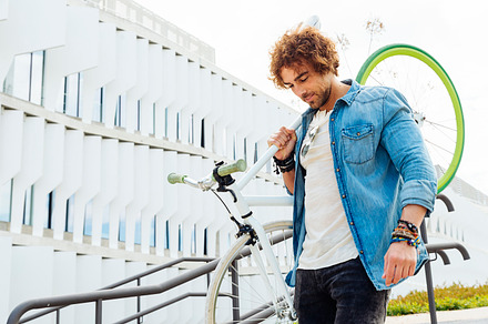 Young man with bicycle in the city stock photo containing man and bicycle, a Person Photo by nunezimage