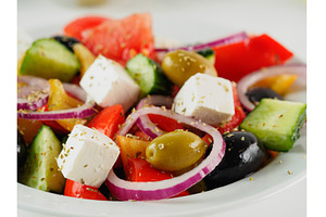 Greek salad on the table, close up, a Food & Drink Photo by Fascinadora