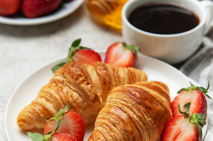 Delicious french breakfast with coffee, honey and croissants acc