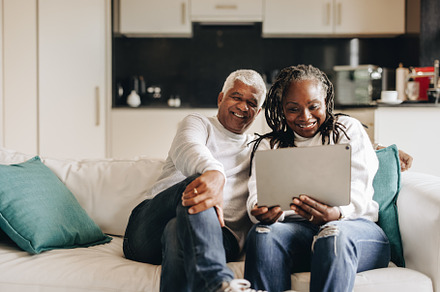 Happy mature couple having a video call on a digital tablet, a Person Photo by Jacob Lund
