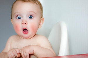 surprised kid sitting at table