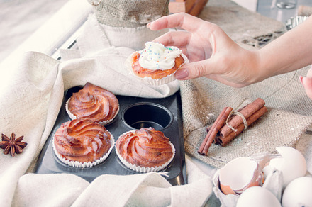 Hand takes one of cupcake