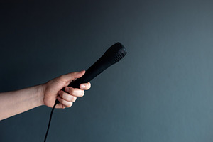 Hand holding microphone, freedom of speech, communication, inter, a Photo by salmon.black