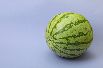 Ripe watermelon on violet background, space for text, a Food & Drink Photo by AtlasStudio PRO
