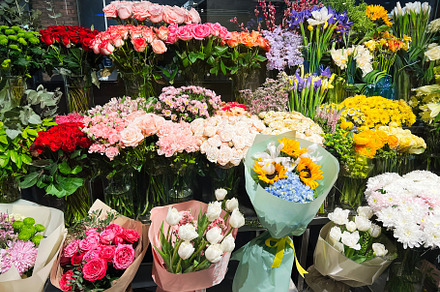 Colorful floral arrangement display at a market showcasing vibrant bouquets and, a Photo by AS photostudio
