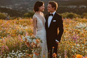 Bride and groom in a wildflower mead, a Photo by Pixeness Studio