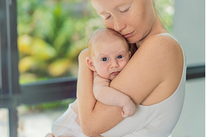 Mother gently hugging her baby at, a Beauty & Fashion Photo by Elizaveta Galitskaya