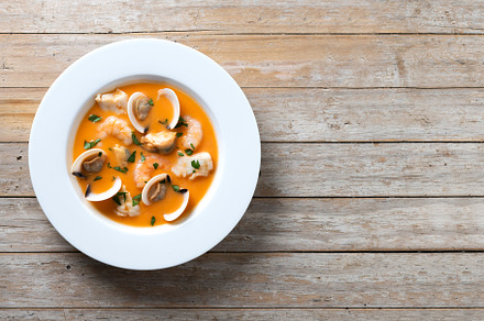 Seafood soup on wooden table. Top view. Copy space, a Food & Drink Photo by etorres69