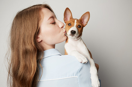 Handsome redhead hair young female containing love, puppy, and dog