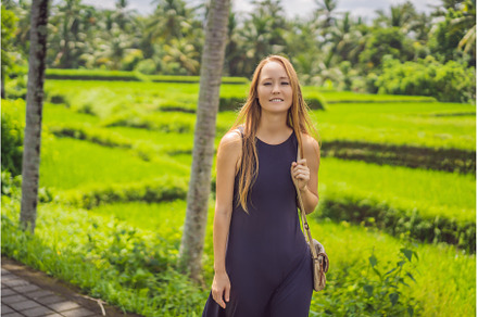 Woman walking in the rice field Bali, a Nature Photo by Elizaveta Galitskaya