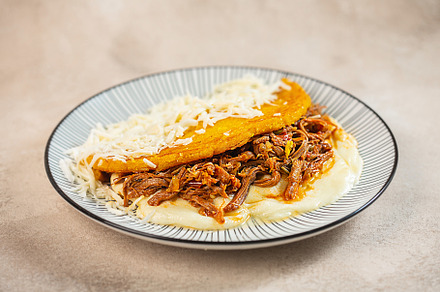 Stuffed arepa made from cornmeal, traditional cuisine of Colombia and Venezuela, a Food & Drink Photo by zakiroff