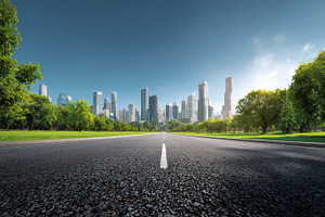 an asphalt road leads into a skyline, a Photo by Pavel_design