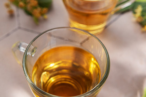 Linden herbal tea in clear cups with lime blossoms, a Food & Drink Photo by Olena Rudo