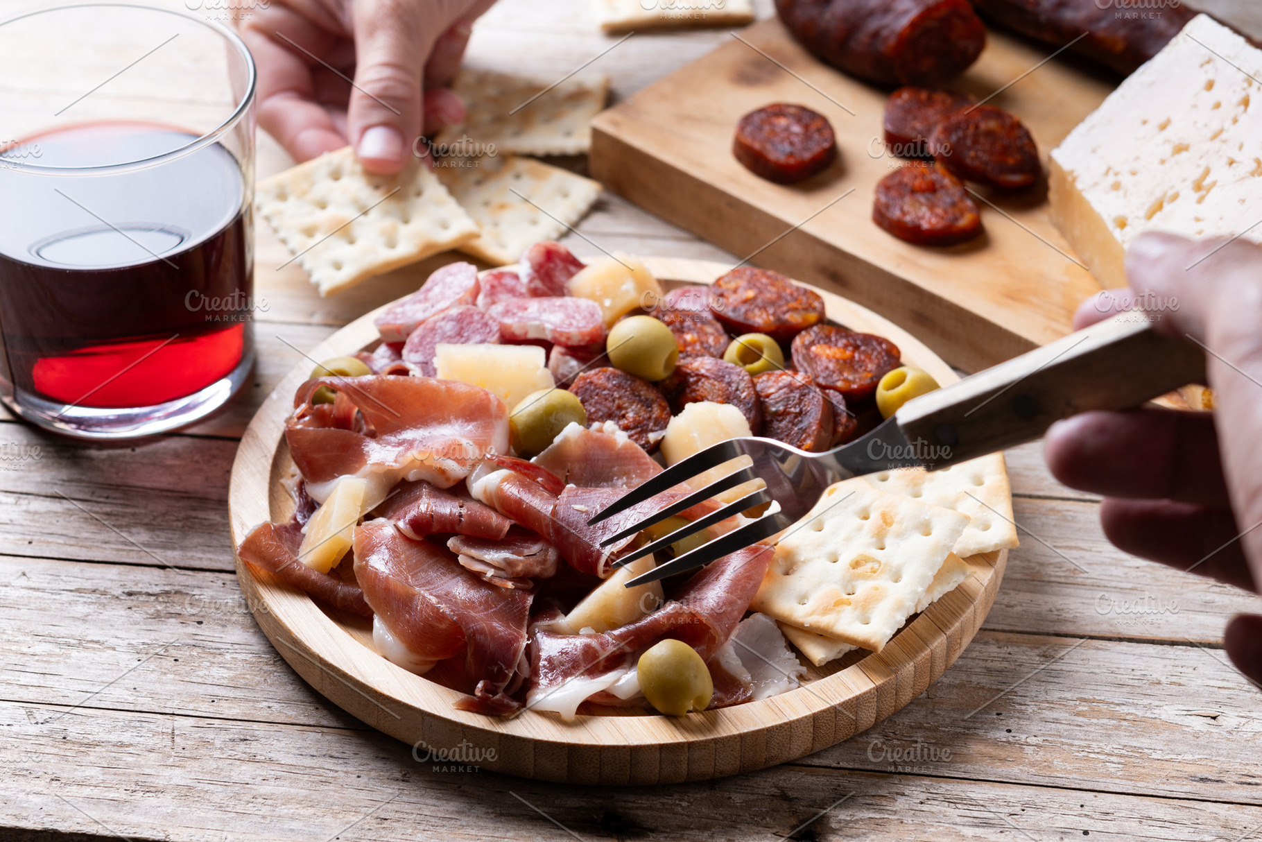 People sharing Spanish tapas with serrano ham, chorizo and red wine, a Food & Drink Photo by etorres69